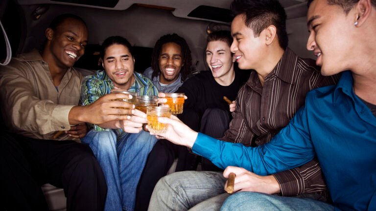 Multi-ethnic men toasting with drinks